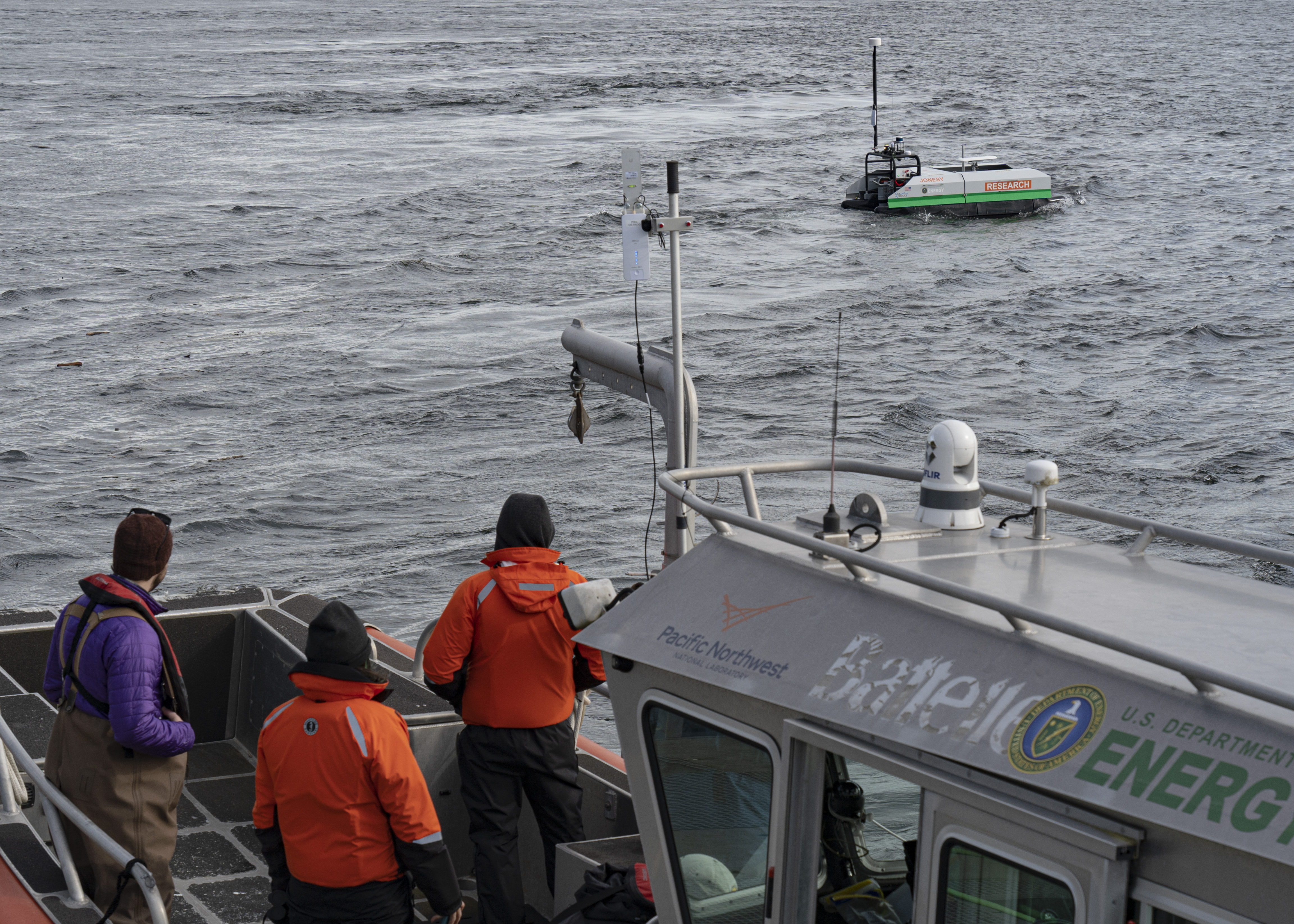 Researchers watch the maiden voyage of the new autonomous surface vehicle from deck of the R/V Desdemona in Sequim Bay