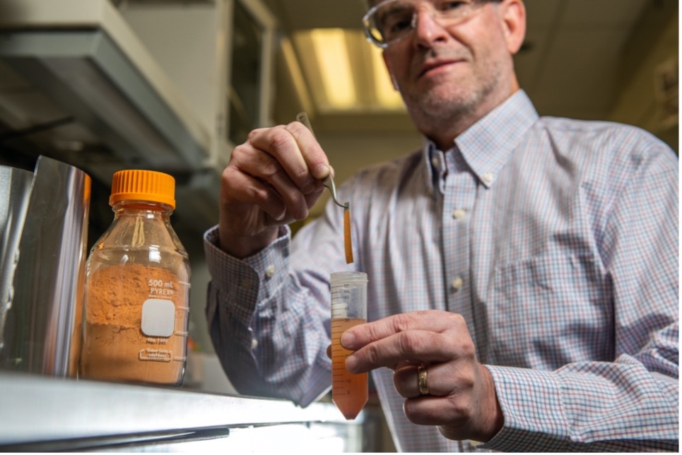 Scientist holding beaker of dessicant