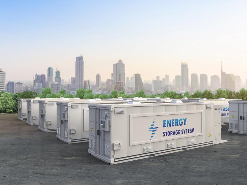 Battery energy storage systems in foreground with cityscape in the background.