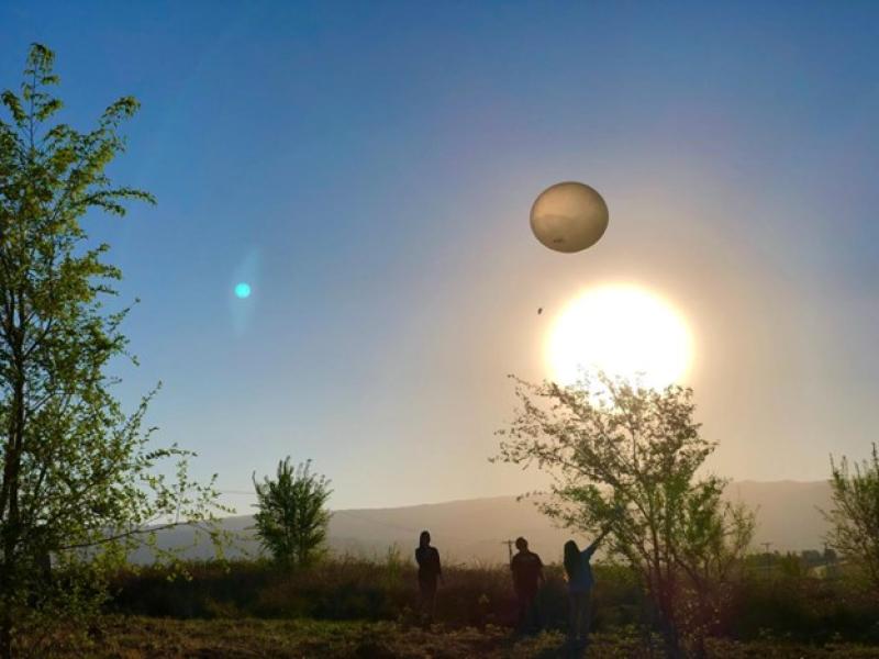 Photograph of measurement balloon in front of a bright sun