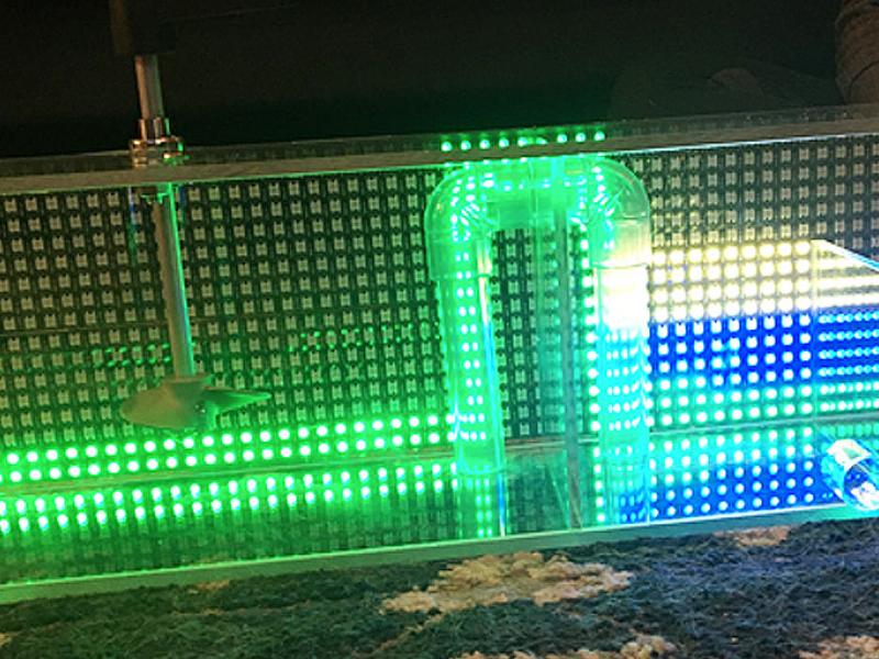 A glowing set of tubes inside a transparent container
