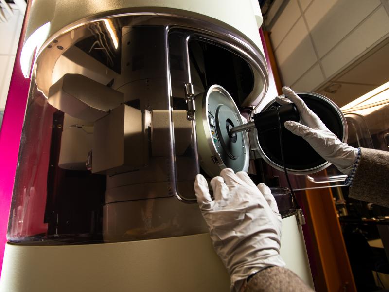 A sample being inserted into a JEOL GrandARM-300F scanning transmission electron microscope at PNNL.