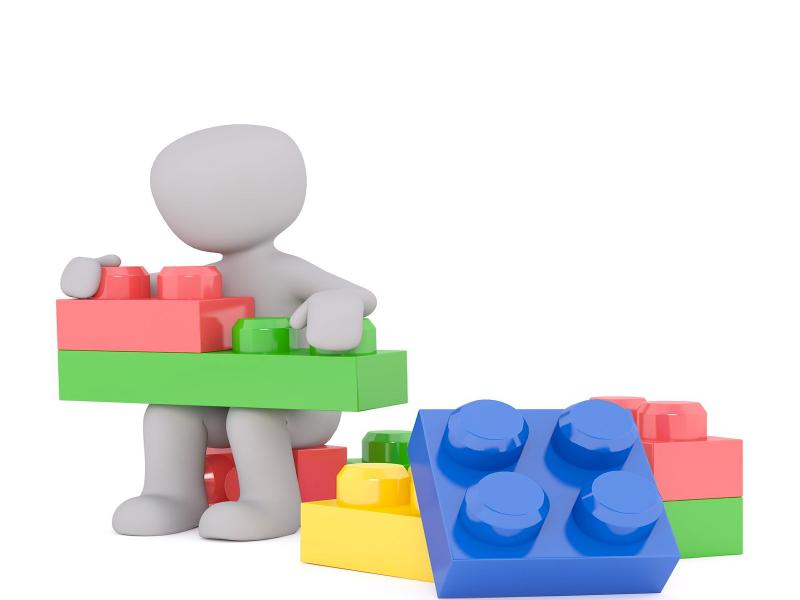 3D render of a clay doll assembling building blocks together