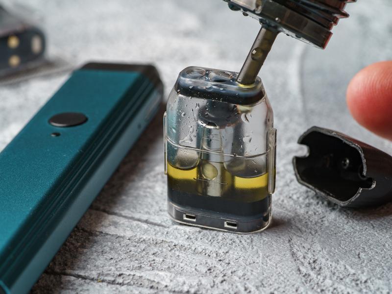 Viscous e-cigarette liquid stands inside a cartridge.