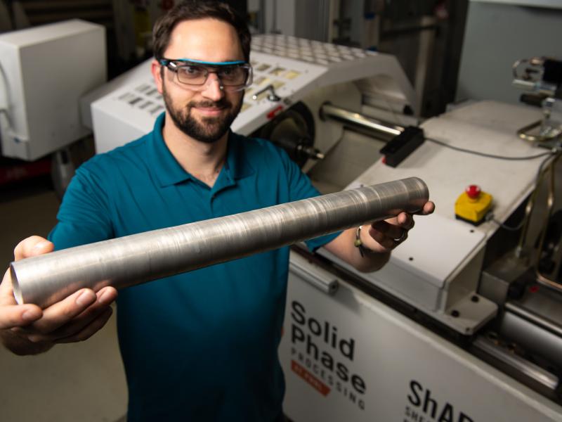 Researcher hold tube extruded by the ShAPE machine